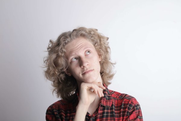 Pensive Male Teen On Gray Background