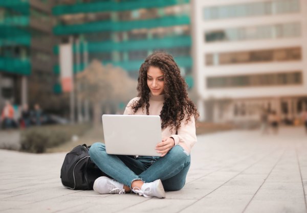 Woman In Pink Sweater Working On A LAptop
