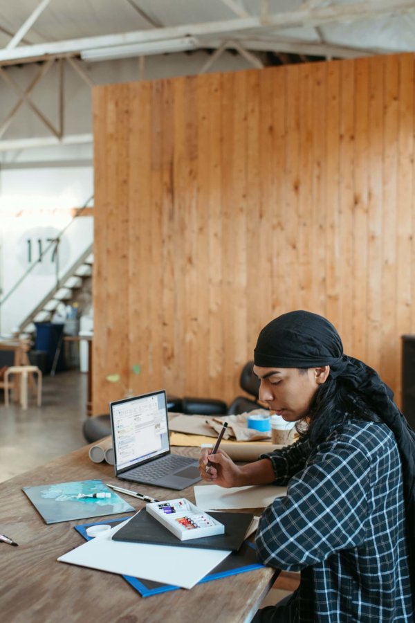 person at desk on laptop