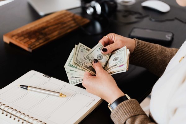 Woman Counting Cash During Audit
