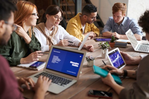 Employees Sitting on a Table Working